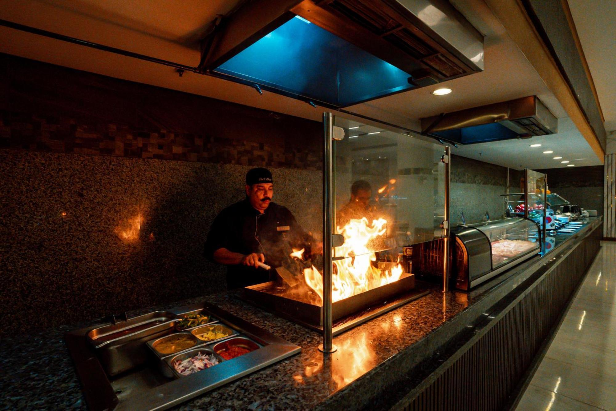 Pyramisa Beach Resort Sahl Hasheesh Hurghada Exterior photo A chef cooking with a flaming torch